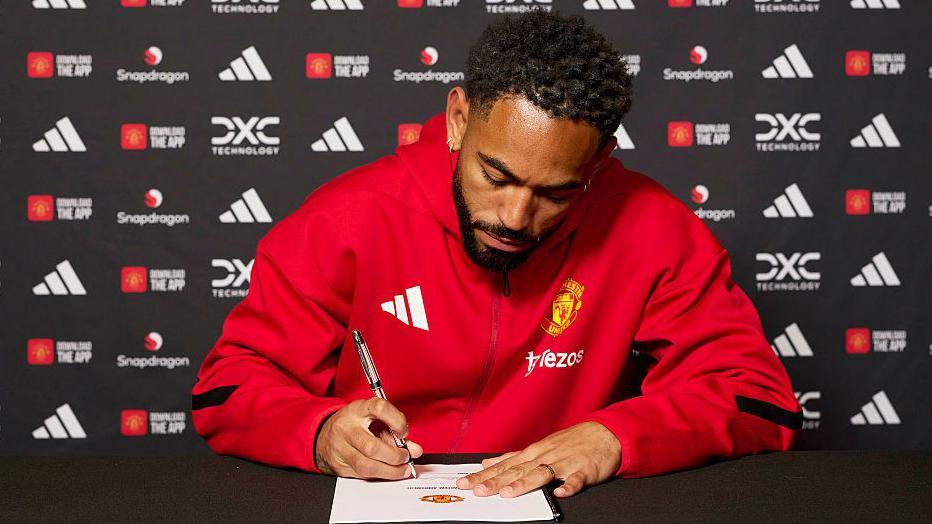 Matheus Cunha signing his Manchester United contract