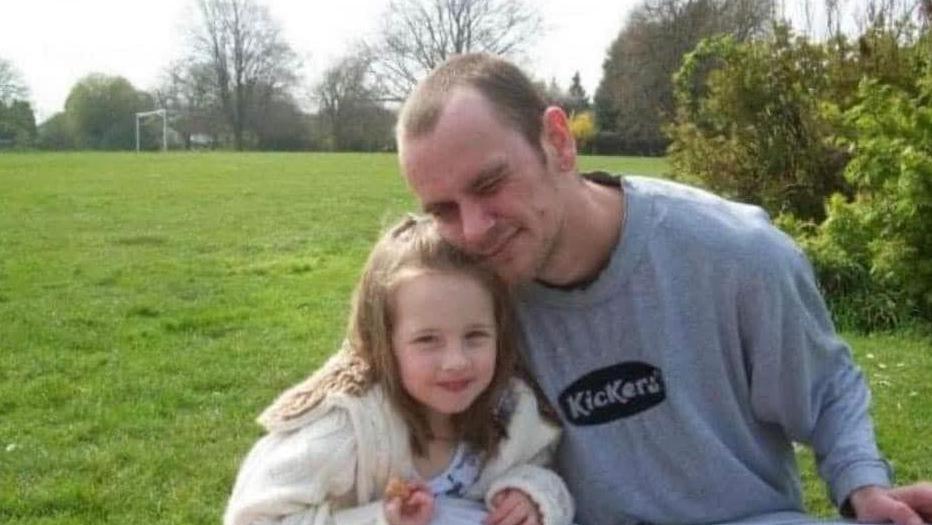 Paul Rowlands, on the right in grey jumper with Kickers image, beside his daughter Lucy with fair hair and white cardigan