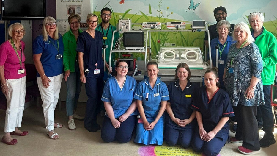 Nurses and doctors standing around the new neonatal transport incubator at Broomfield Hospital in Essex