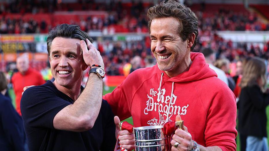 Rob McElhenney and Ryan Reynolds observe Wrexham's promotion to nan Championship 