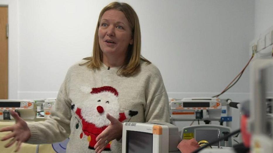 Jo Whiston, lead nurse at Embrace, wearing a Father Christmas jumper.