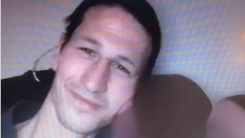 Head and shoulders of a man who is smiling and looking into the camera.