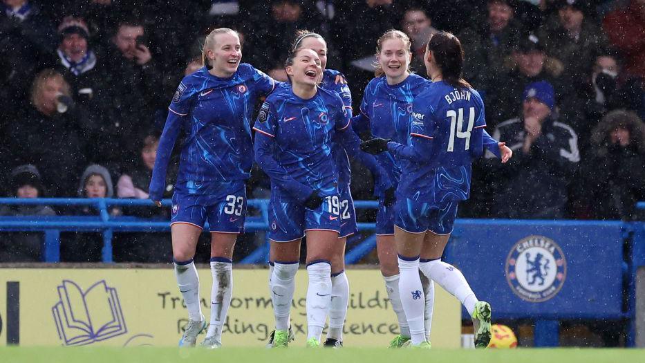 Chelsea players celebrate their third goal against Brighton