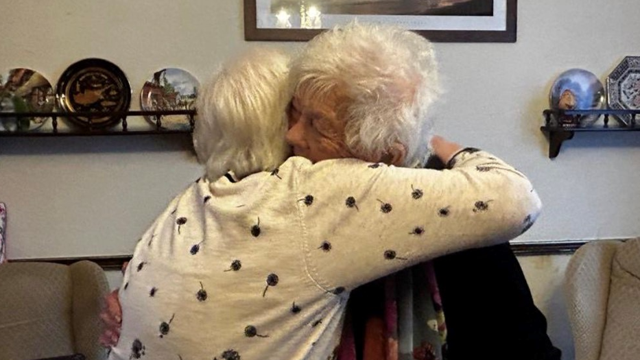 Doreen and Beryl embrace