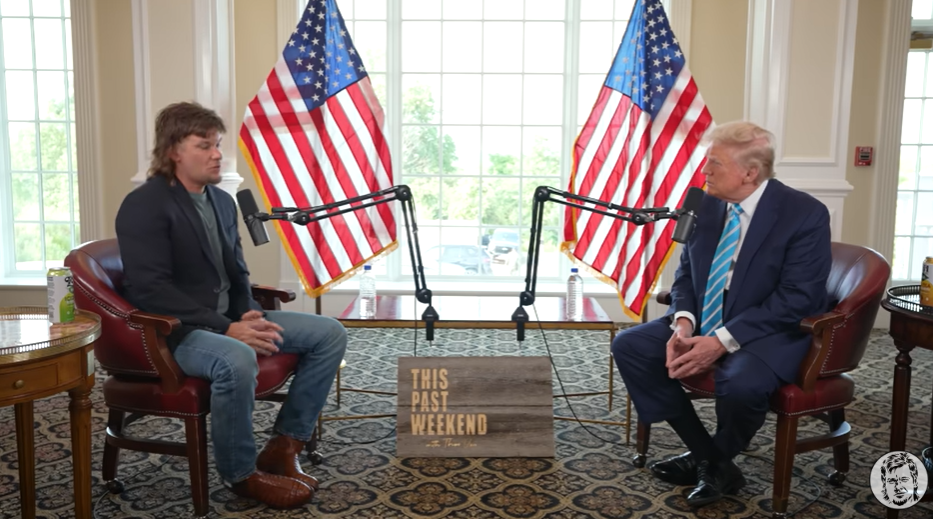 Theo Von sat on chair oppposite a seated Trump