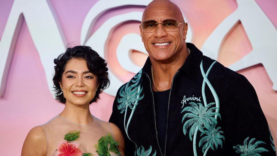 US actress Auli'i Cravalho (L) and US actor Dwayne Johnson pose on the red carpet upon arrival for the UK Premier of "Moana 2", at the Cineworld, in Leicester Square, in central London, on November 24, 2024.