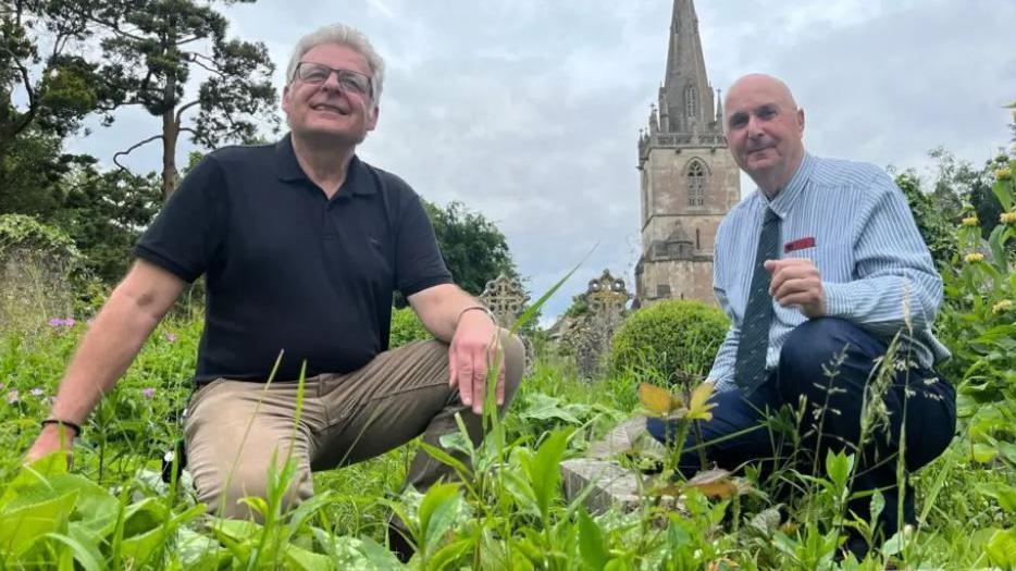 Paul and Julian crouched down next to the grave when it was covered in weeds.