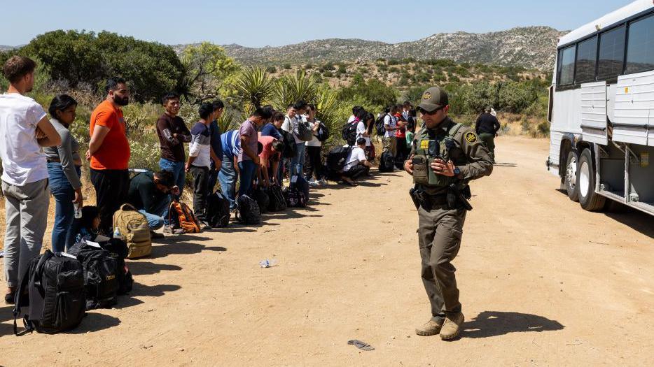 Undocumented migrants being processed north of the US-Mexican border