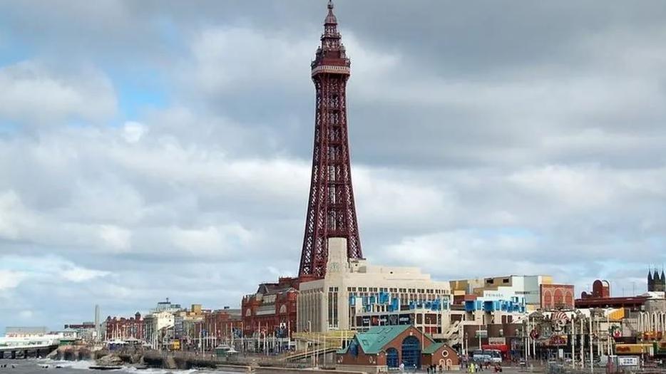 Blackpool Promenade showing part of the sea and Blackpool Tower (centre) and North Pier to the left