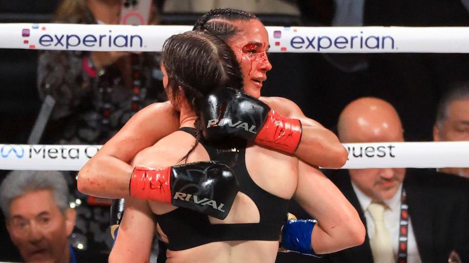 A bloodied Katie Serrano hugs Katie Taylor