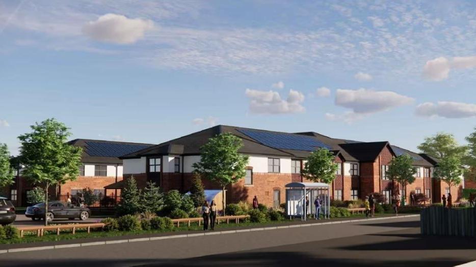 An artist's impression of a two-storey care home. It has brown brick with a white finish and a grey roof with solar panels. A number of trees can also be seen at the front of the development. 