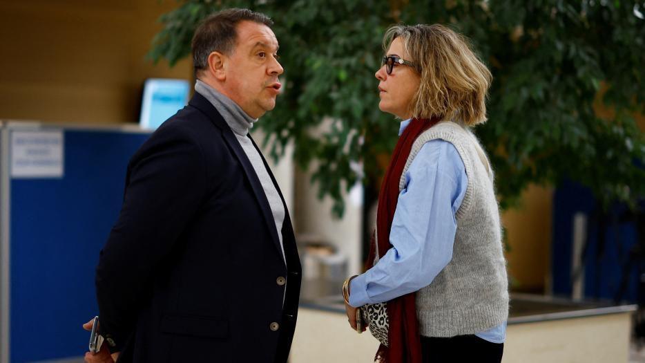 Caroline Darian on the right and wearing a scarf talks to her brother David during a break in the Avignon trial