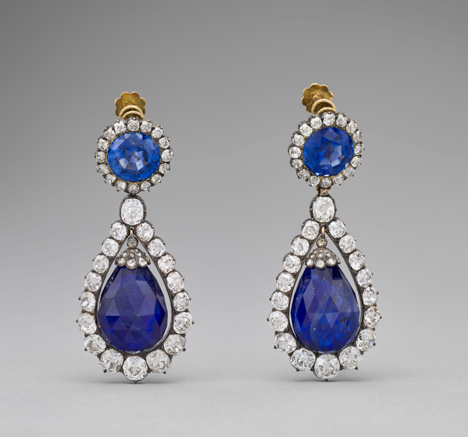 A pair of diamond and blue emerald encrusted earrings 