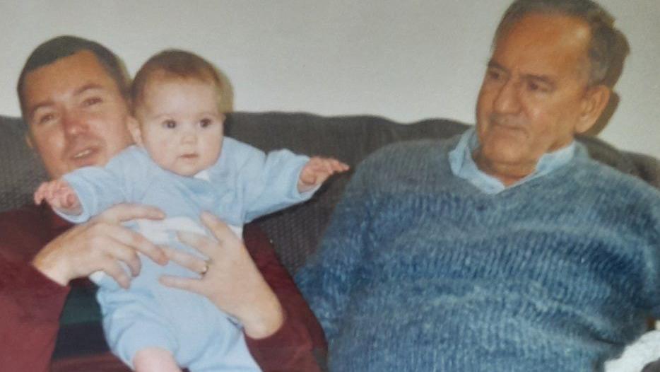 Tan Hughes holds his daughter whilst sat next to his father, Frank Hughes in 1994