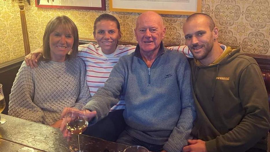 Dave Jones sitting with members of his family at a restaurant