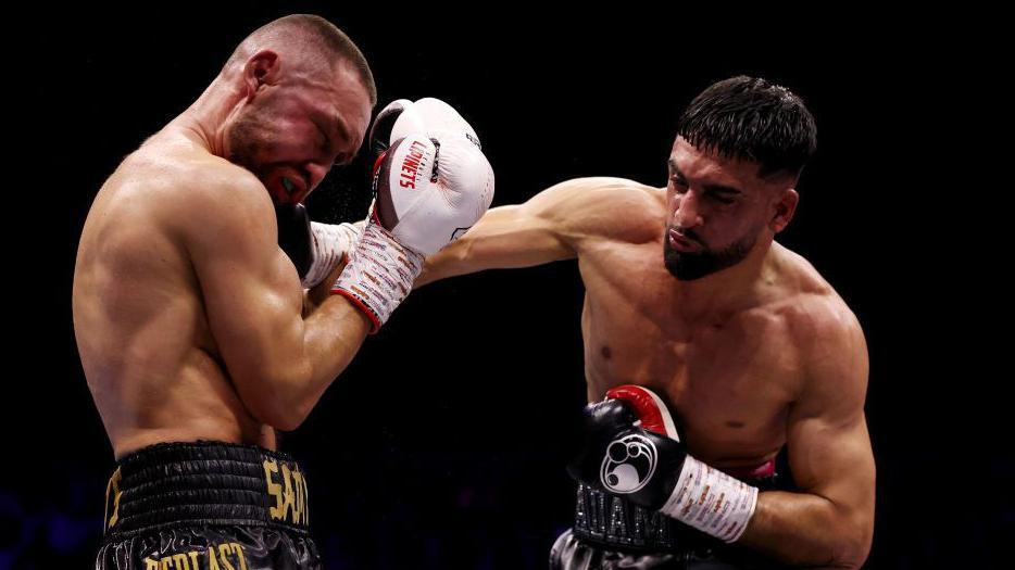 Adam Azim throws a punch in the ring