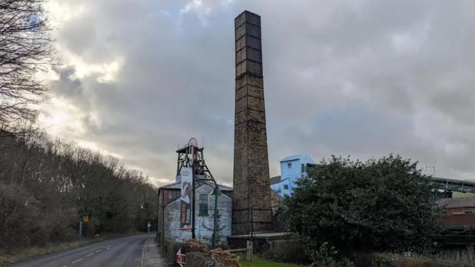 National Coal Mining Museum in Overton, Wakefield, formerly Caphouse Colliery. Road and trees to the left.