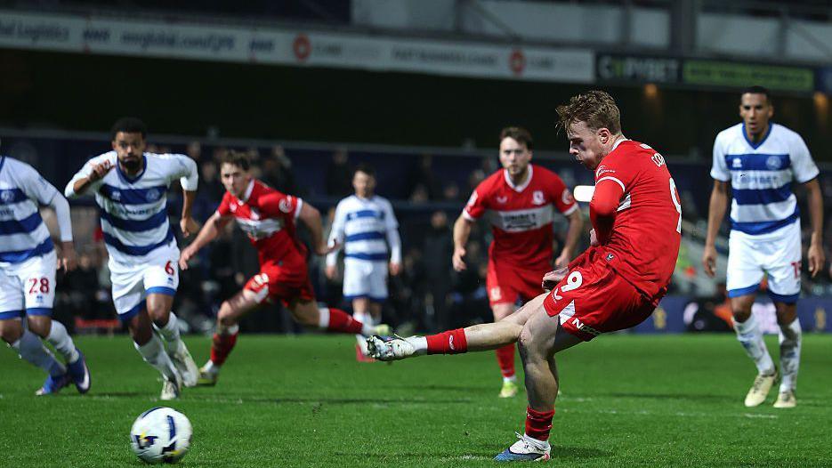 Tommy Conway shoots from the penalty spot, with Middlesbrough and QPR players in the background