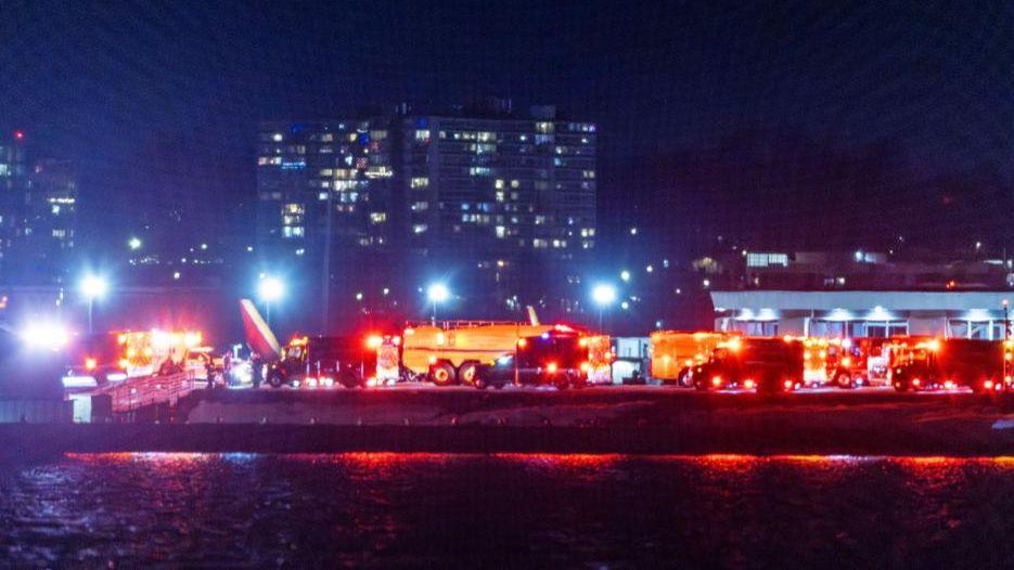 Rescue teams gather to respond to an airplane crash in the Potomac River near Ronald Reagan National Airport in Washington, DC