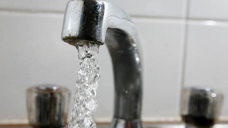 A silver tap pouring out water