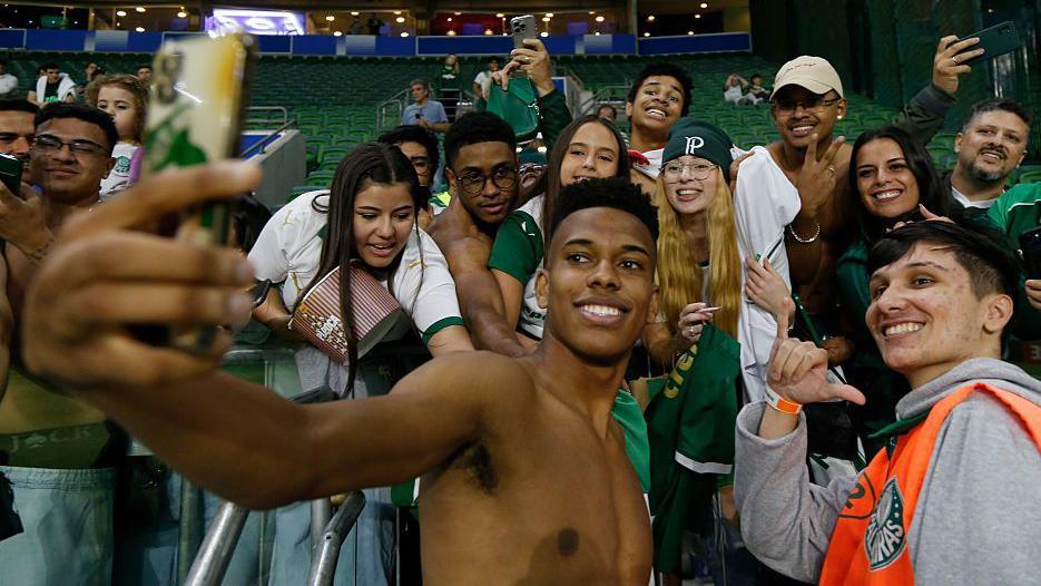 Estevao Willian poses for a selfie with a group of Palmeiras fans