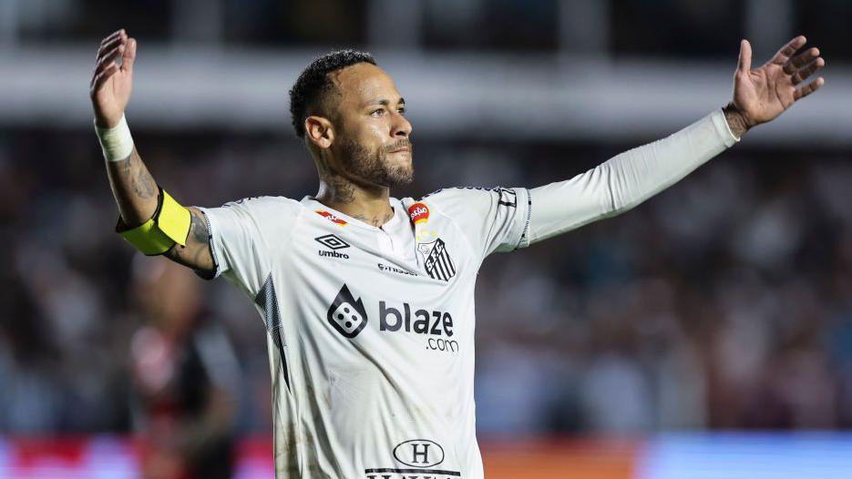 Neymar on pitch with his arms stretched out wide