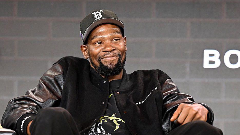 Kevin Durant smiles during a media conference