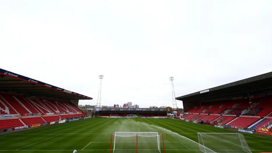 The pitch at Swindon Town's County Ground. The stands are left and right of the pitch, with the goal centre of the image.