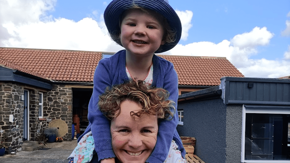 Rose O'Leary Hall on the shoulders of her mum Katie