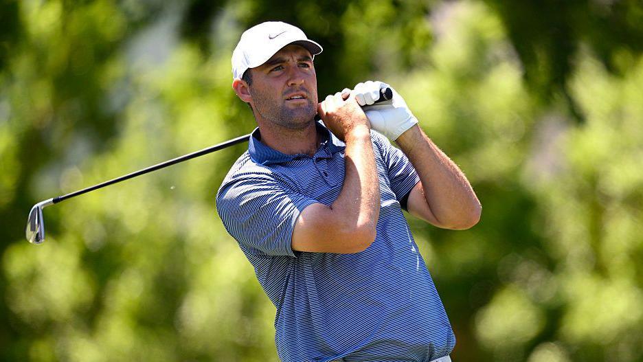 Scottie Scheffler watches his shot