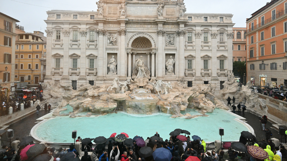 A general view shows the Trevi fountain after renovation works in Rome, on the day of its reopening with crowds of people huddling round the grand re-opening.