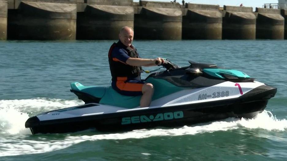 Liberal Democrat leader Sir Ed Davey on a water scooter off the Sussex coast.