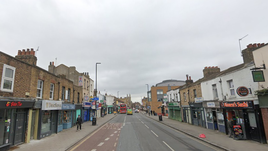 A Google street view of a street with shops lining the side