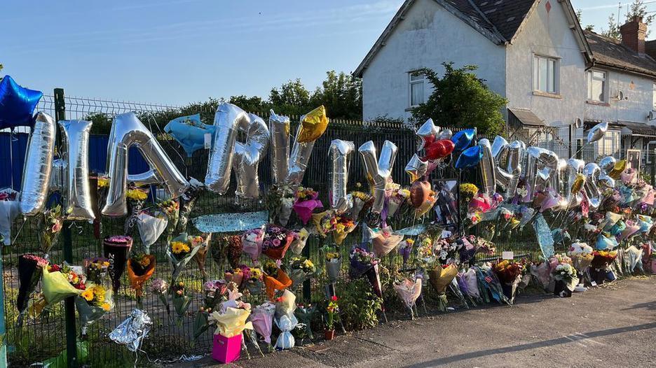 Floral and balloon tributes left on a fence to Harvey and Kyrees