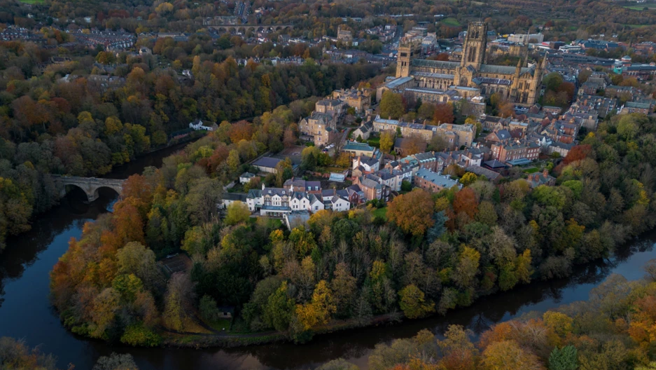 Drone shot of a Durham Cathedral and its surrounding buildings, trees and river