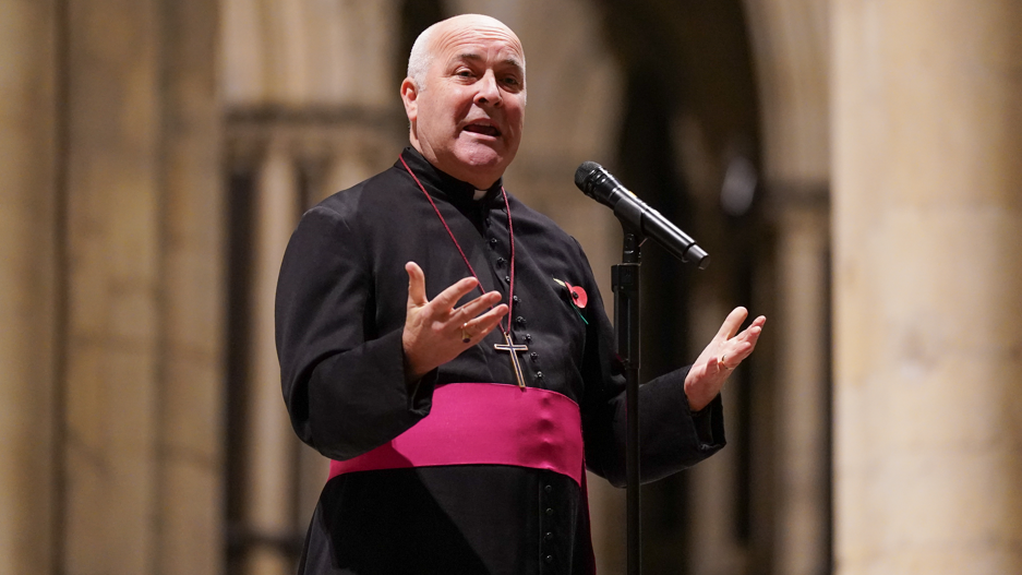  Archbishop of York, Stephen Cottrell speaks to a gathered congregation in York Minster. He is wearing the black and pink robes of the archbishop