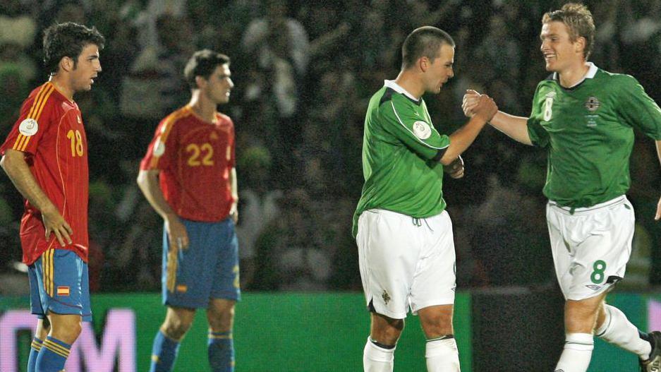 David Healy celebrates one of his three goals with Steven Davis