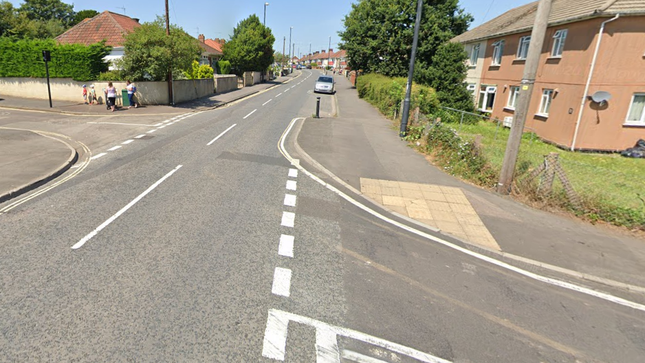 A google street view image of Broomhill Road in Brislington. It is a sunny summer's day and some green bushes and trees are visible either side of the houses