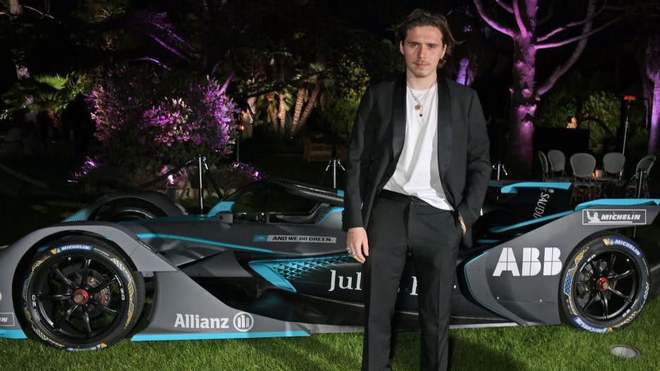 Brooklyn Beckham poses in front of the safety car at the Mexico E-Prix in 2020