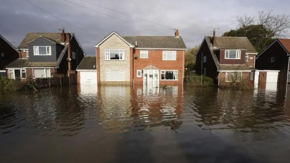 Four detached houses in Fishlake under floodwater in November 2019, with water rising several metres above ground level