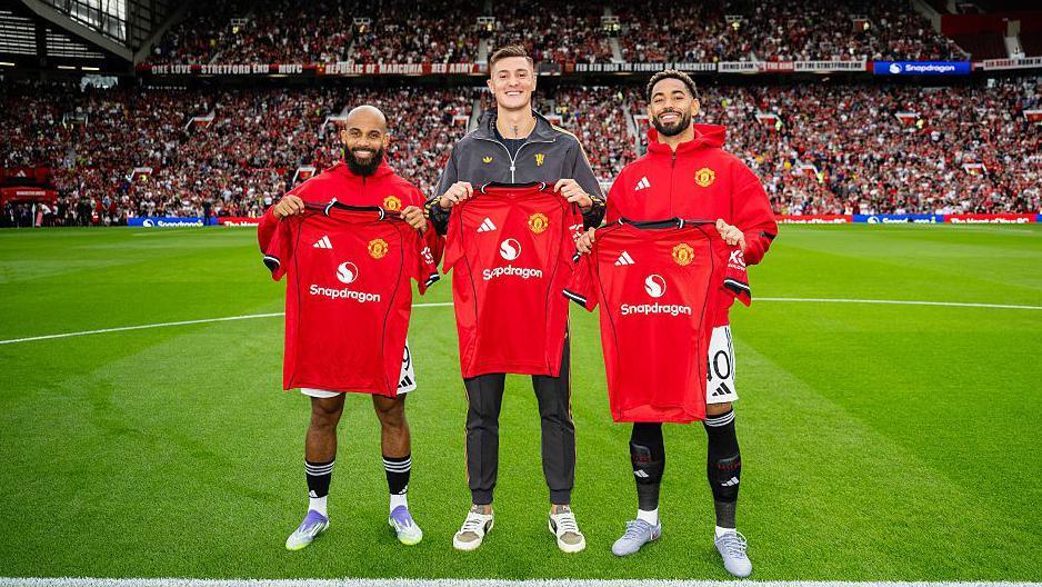 New Manchester United signings Bryan Mbeumo, Benjamin Sesko & Matheus Cunha pose together with team shirts prior to the pre-season friendly match between Manchester United and ACF Fiorentina at Old Trafford 