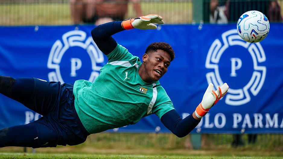 Zion Suzuki dives to make a save while warming up for Parma