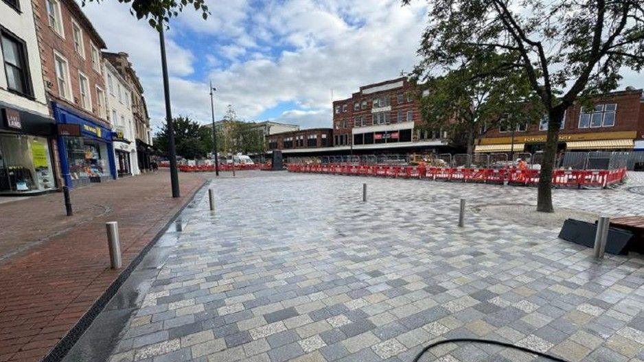 The new paved area between Saludo Lounge and Lakeland. The central area still has fencing on, where work is ongoing.