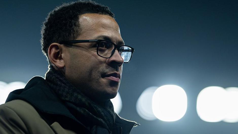 Liam Rosenior looks on with lights in background