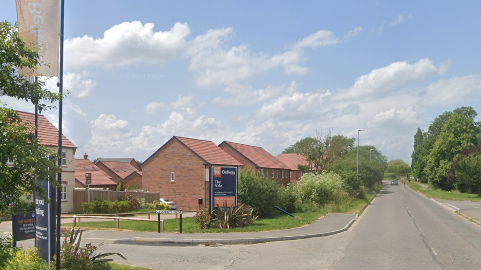 The entrance to a new build estate sat on a main road into a village