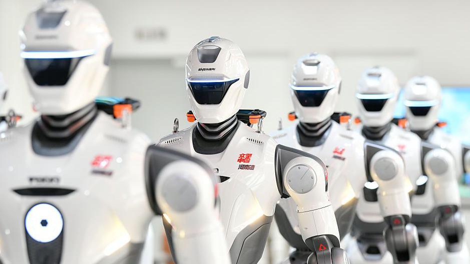 A row of humanoid robots are on display after rolling off the production line at a production facility in China