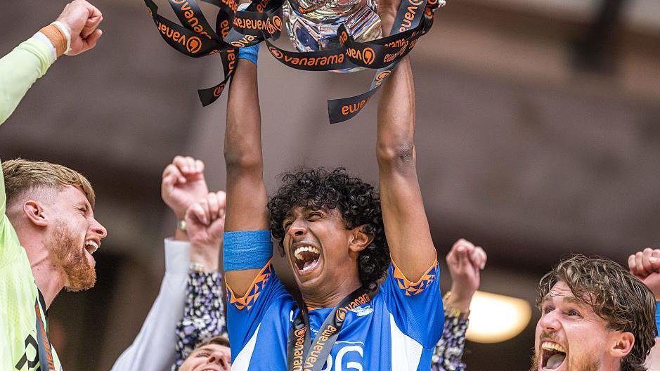 Vimal Yoganathan of Oldham Athletic lifts the trophy during the Vanarama National League play-off final