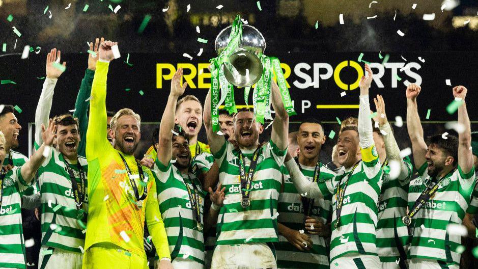 Celtic's Anthony Ralston lifts the Premier Sports trophy after the Premier Sports Cup Final between Celtic and Rangers at Hampden Park, on December 15, 2024