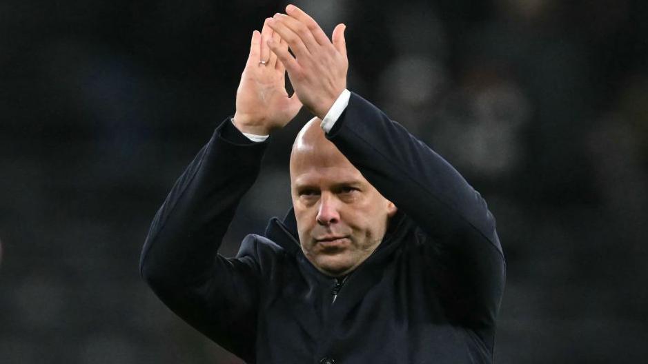 Liverpool Head Coach Arne Slot acknowledges the fans at the end of the emphatic victory at Spurs