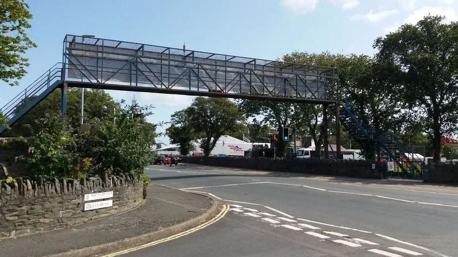 A metal footbridge over a road